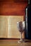 Vintage shabbath silver cup of wine in front of torah prayer book