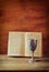 Vintage shabbath silver cup of wine in front of torah prayer book