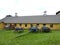 Vintage Shaker Farm wagons in front of yellow barn