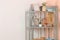 Vintage shelf with dishes in the corner of the room against the white and peach walls. antique shelf. interior