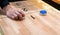 Vintage shuffle board game with red and blue disc and hand holding red blue disc on wooden shuffle table. Shuffleboard table game