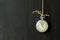 A vintage silver-rimmed stopwatch hanging .