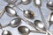 Vintage silver teaspoons on metal table