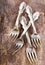 Vintage silverware forks on rustic wooden table