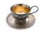 Vintage silverware, very old rich decorated metal cup for coffee on a saucer isolated on a white background, close up