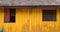 Vintage simple wood house with yellow wooden wall and rustic