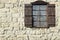 Vintage Single Window with Wooden Shutters on Natural Stone Wal