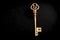 Vintage skeleton key in copper, isolated on a black background