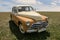 Vintage soviet car Pobeda on a field with green grass