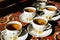 Vintage soviet porcelain cups of tea with saucers on turkish carpet, traditional tea ceremony, sunlight