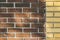 Vintage split color brown and yellow brick wall background texture