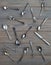 Vintage spoons, forks, knives and metal plates on a gray wooden background