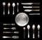 Vintage spoons, knives, forks and a plate isolated on a white background.