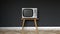 vintage steel and metal television levitating on a gray background, noise in the screen