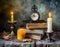 Vintage still life with antique books, clock and candle. Halloween and occult concept