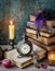 Vintage still life with antique books, clock and candle. Halloween and occult concept