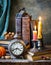 Vintage still life with antique books, clock and candle. Halloween and occult concept