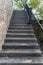 Vintage stone stairs black metal banister for decoration exterior for home and living achitecture decoration. Vintage house contem