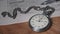 Vintage Stopwatch Lies on Wooden Desk with Old Documents and Counts Seconds