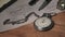 Vintage Stopwatch Lies on Wooden Desk with Old Documents and Counts Seconds