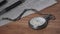 Vintage Stopwatch Lies on Wooden Desk with Old Documents and Counts Seconds