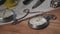 Vintage Stopwatch Lies on Wooden Desk with Old Documents and Counts Seconds