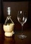 Vintage straw bottle of wine and glass wine