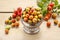 Vintage striped box of rose hip fruits on wooden table