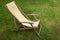 Vintage striped collapsible garden chair on the lawn