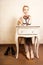 Vintage style. Barefoot girl sitting at retro desk