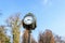 Vintage style black and grey metallic clock towards clear blue sky in King Michael I Park (Herastrau) Park