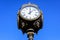 Vintage style black and grey metallic clock towards clear blue sky in Unirii Park Parcul Unirii, in Bucharest, Romania, in a