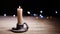 Vintage style candle flickers in candle holder with bokeh lights background