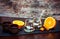 Vintage style ceramic cups, fresh orange, tiramisu dessert in glass jars and chocolate candies