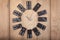 Vintage style clock made of domino plates on wooden background. Domino clock