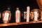 Vintage style illuminated light bulbs on wooden surface, warm amber glow.