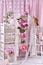 Vintage style interior with white shelves and metal mannequin decorated with flowers