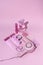 Vintage style layout with pink hairdryer, scissors, bottle, make up and cassette tape on pastel background