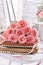 Vintage style picture with bunch of pink roses lying on books