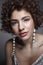 Vintage style portrait of beautiful girl with curly hair and glossy party makeup, soft focus
