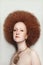 Vintage style portrait of beautiful woman with fancy makeup and afro hair