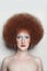 Vintage style portrait of beautiful woman with fancy makeup and afro hair