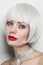 Vintage style portrait of beautiful woman with platinum blonde hair and red lips