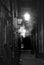 Vintage style sepia view of an old dark narrow city alley with lamplight and fog known as turks head yard in briggate leeds