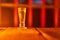 Vintage style single shot glass iluminated by red candle light.