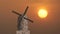 Vintage style wind mill against golden red sunset animation video