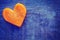 Vintage stylized heart made of carrot on grunge background.