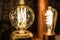 Vintage stylized round tungsten lamp glowing in dark, close-up photo with selective focus and shallow DOF