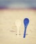 Vintage stylized two porcelain spoons stuck in sand