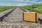 Vintage suitcase in middle of railroad tracks on the prairies